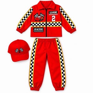 May include: A red racing-themed outfit consisting of a long-sleeve zip-up jacket, matching pants, and a baseball cap. The jacket features a black and white checkered stripe, a red car graphic, the name LIAM, the number 2, and the text RACING.
