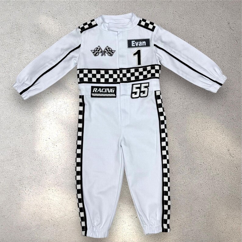May include: White racing jumpsuit with black accents, featuring a checkered flag design, the name "Evan", and the numbers "1" and "55". The jumpsuit has long sleeves and a "RACING" patch.