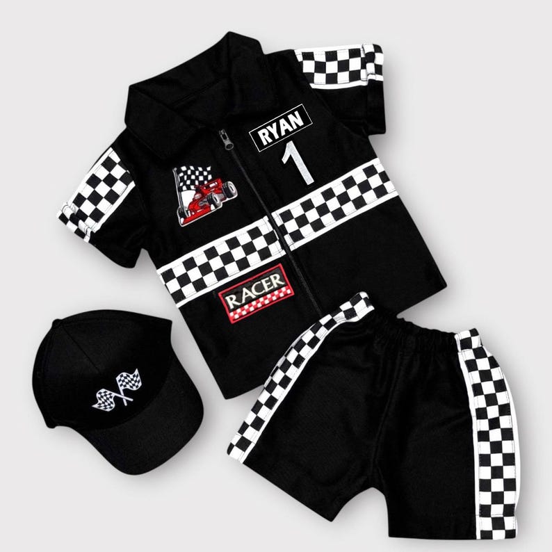 May include: A black short-sleeved collared shirt with a zipper, featuring a checkered pattern on the sleeves and chest, the name RYAN, the number 1, a red race car graphic, and the word RACER. Includes matching black shorts and a black baseball cap.