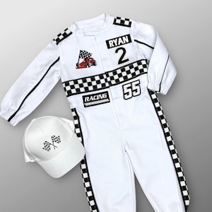 May include: White racing jumpsuit with black and white checkered accents, black stripes, and the name "RYAN" and number "2". Includes a matching white baseball cap with checkered flags. The jumpsuit has the number "55" and the word "RACING".