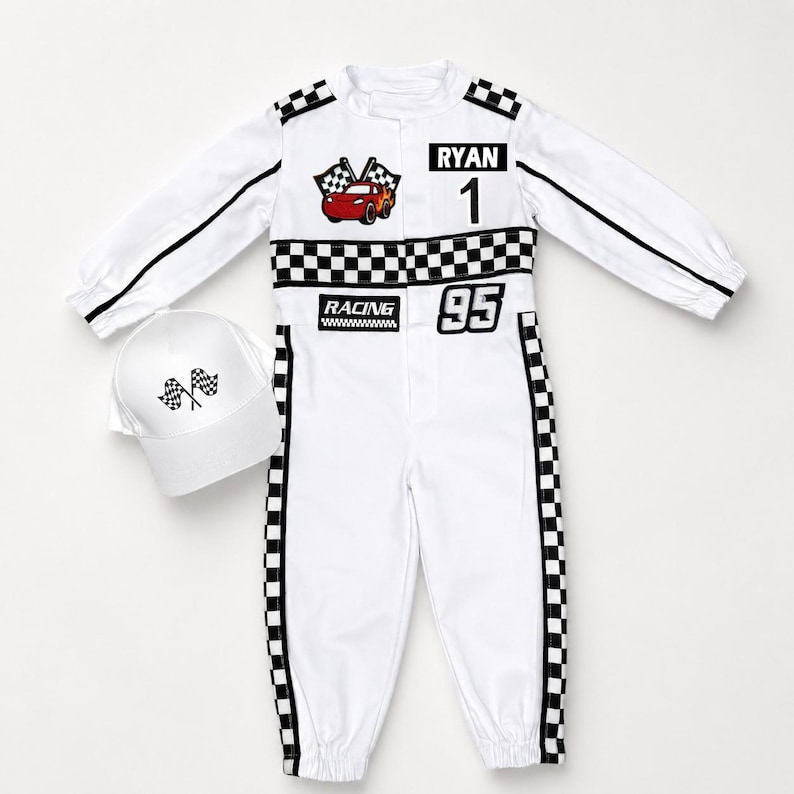 May include: A white long-sleeve racing jumpsuit with black and white checkered trim, featuring a red car graphic, the name RYAN, the number 1, the word RACING, and the number 95. A matching white baseball cap with a checkered flag graphic is included.