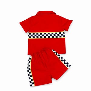 May include: A bright red short-sleeved collared shirt and matching shorts set. The shirt features a horizontal black and white checkered band across the chest. The shorts have vertical black and white checkered side stripes with yellow trim.