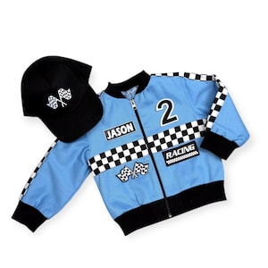 May include: A light blue racing jacket with black and white chequered accents, a black zip, and the number 2. The jacket has the name "JASON" and the word "RACING" on it. A black baseball cap with chequered flags is also included.