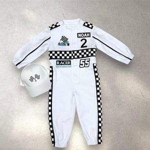 May include: White racing jumpsuit with black accents, a checkered waist band, and the name "Noah" and the number "2" on the chest. Includes a matching white hat with checkered flags. The jumpsuit has the number "55" on the leg.