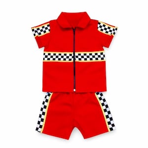 May include: A bright red short-sleeve shirt with a full-length front zipper and a matching pair of shorts. Both pieces feature a black and white checkered pattern trim along the sleeves, the chest, and the sides of the shorts with yellow accents.