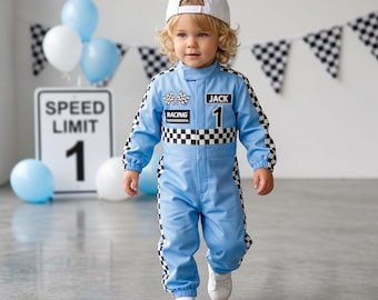 May include: A light blue racing jumpsuit with a black and white checkered pattern along the waist, sleeves, and legs. The chest features a checkered flag emblem, the word RACING, and the name JACK above the number 1. A white baseball cap is worn.
