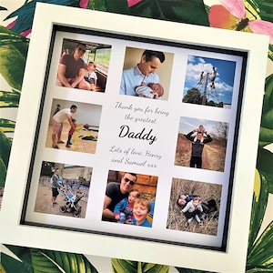 Puede incluir: Un marco de fotos blanco con un collage de fotos de un padre y sus hijos. El texto "Thank you for being the greatest Daddy Lots of love, Henry and Samuel xxx" está impreso en el marco.