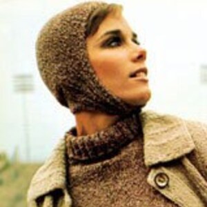 May include: A brown knitted hat with a long flap that covers the neck and ears. The hat is made of a soft, textured yarn.