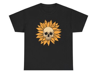 May include: Black t-shirt featuring a distressed graphic of a skull at the center of a sunflower. The sunflower has yellow petals and a tan center, with the skull in the center. The design has a vintage, slightly worn look.