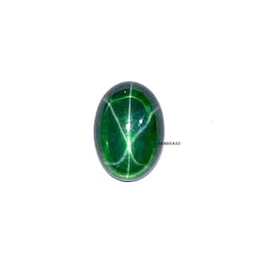 May include: An oval-shaped, polished green gemstone with a star pattern. The gem has a smooth, glossy surface and a vibrant, emerald hue. The star effect is created by intersecting lines across the surface. The gem is set against a white background.