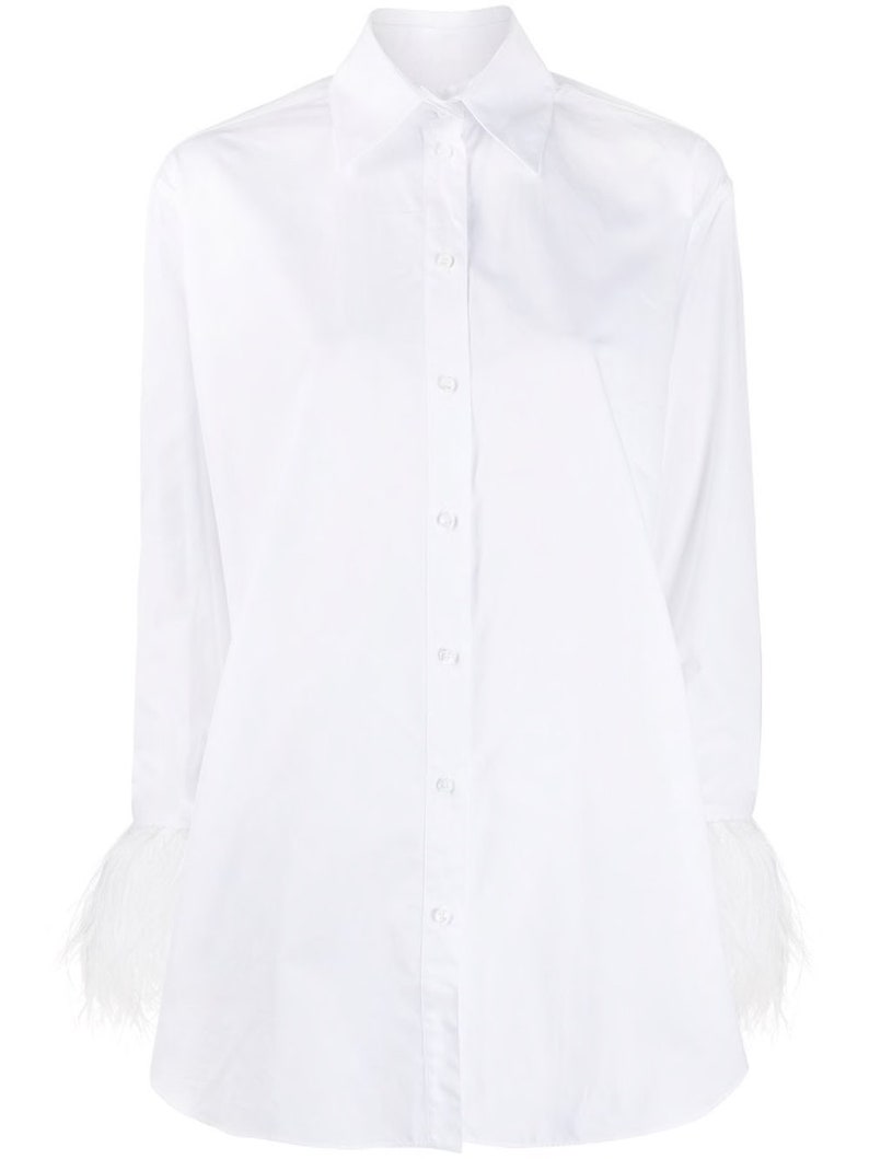 May include: A white long-sleeved button-down shirt with feather trim on the cuffs.