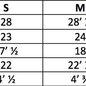 May include: Size chart for a garment with measurements in inches for top length, chest, shoulder, sleeve length, and cuff. Sizes include XS, S, M, L, and XL.