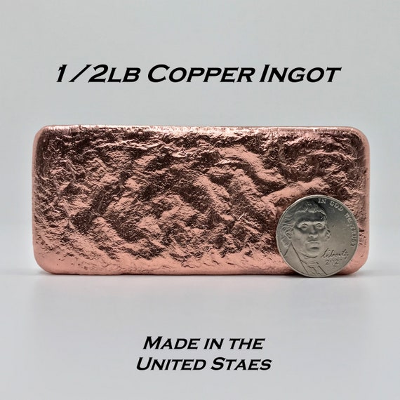 Single copper ingot on rows of shiny copper ingots or bars