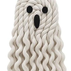 May include: A handmade Halloween ghost decoration. The ghost is made of off-white rope with a round head and wavy body. It has three black circular eyes and a black oval mouth. A black string is attached for hanging.