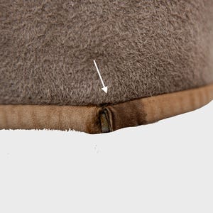 Get cozy in style with this vintage 80s shearling coat in brown. Its timeless design and soft warmth will have you feeling snug and stylish all season long. Don't miss out on this irresistible call to coziness!