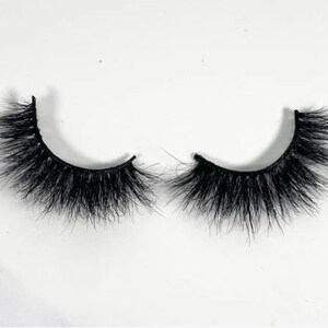 May include: A pair of black false eyelashes with a natural, wispy look. The lashes are designed to add volume and length to the natural lashes.