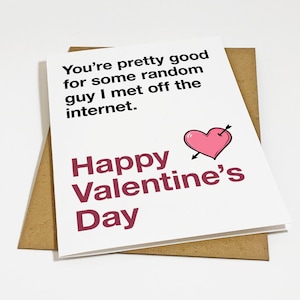May include: A Valentine's Day card with a white background and a brown envelope. The card has the text "You're pretty good for some random guy I met off the internet." and "Happy Valentine's Day." A pink heart with an arrow is also on the card.