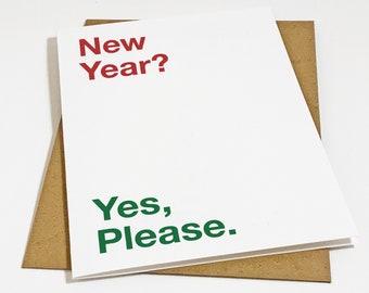 May include: A white greeting card with the red text New Year? printed at the top left and the green text Yes, Please. printed at the bottom left, resting on top of a plain brown paper envelope. The card features a clean, simple design.