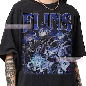 May include: Black t-shirt featuring a graphic of anime characters with blue hair and the word "FLINS" in blue. The design has a vintage, distressed look. The shirt is a casual wear item.
