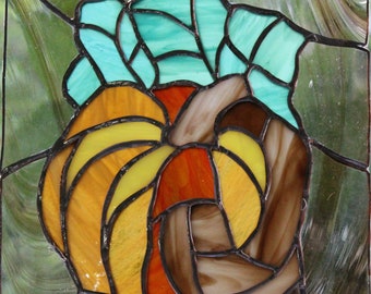 Hand made, stained glass, pumpkin sun catcher in fall colors.