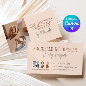 May include: Gold hoop earrings displayed on a light brown surface next to business cards. The business cards read "ENCHANTED JEWELRY by Michelle" and "MICHELLE ROBINSON Jewelry Designer". A blue and purple "Editable with Canva" graphic is also present.