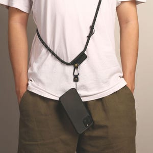 May include: A set of three ceramic mugs with a speckled, matte finish. The mugs are in shades of cream, light gray, and dark gray. Each mug has a simple, minimalist design and a rounded handle.