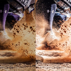 May include: A baseball player slides into home plate, kicking up a cloud of brown dirt. The player is wearing white cleats, purple socks with a white logo, and a white and purple jersey.