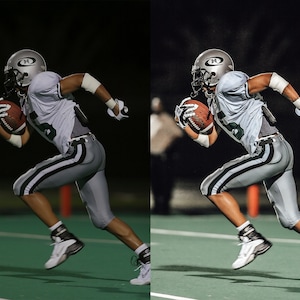 May include: A football player wearing a white and gray uniform with a silver helmet runs with the ball on a green field under the lights.