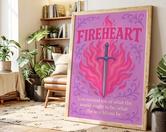 May include: A framed print with the word "FIREHEART" in pink, above a sword surrounded by pink flames on a purple background. The print also includes the quote, "You remind me of what the world ought to be; what the world can be."