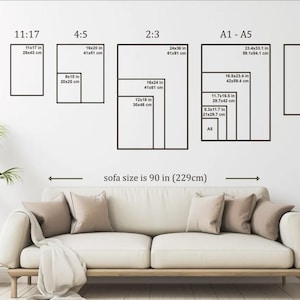 May include: A wall with various rectangular black frames displaying different aspect ratios and sizes, including 11x14 in (28x36 cm), 16x20 in (41x51 cm), and 24x36 in (61x91 cm). The text "sofa size is 90 in (229cm)" is below the frames.