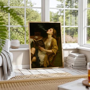May include: Framed art print of a woman smoking and reading a book titled "SLOW BURN ROMANCE." The artwork features a woman in a yellow and white dress, seated in a chair. The print is displayed in a bright room with a window.