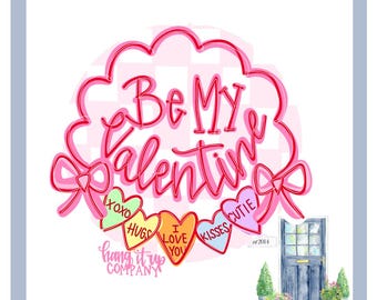 May include: Pink and red graphic with the text "Be My Valentine" in a heart-shaped frame.  The graphic includes a garland of candy hearts with the words "XOXO", "Hugs", "I Love You", "Kisses", and "Cutie".  The text "Hang It Up Company est. 2014" is below the graphic.