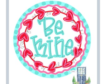 May include: A round sign with the words "Be Mine" in turquoise script, surrounded by red hearts and a pink and turquoise border. A small illustration of a blue door with potted plants is in the lower right corner.