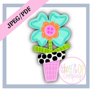 Può includere: Un fiore turchese con un centro rosa e arancione in un vaso a pois neri e bianchi con una base rosa. Il vaso è su uno sfondo bianco. Il testo "Hang It Up Company" è in un cerchio sotto il vaso.