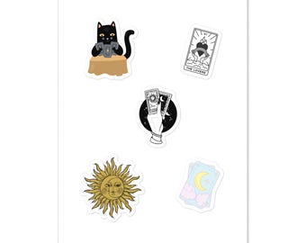 May include: A collection of five stickers featuring mystical designs: a black cat reading tarot cards, a Lovers tarot card, a hand holding sun and moon cards, a golden sun and moon face, and two light blue cards with a yellow crescent moon.