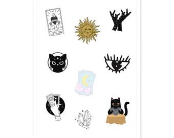 May include: A sticker sheet featuring various illustrations including a Lovers tarot card, a golden sun with a face, celestial hands, a black cat head, an eye, pastel tarot cards, a hand holding cards, a crystal cluster, and a cat at a table.