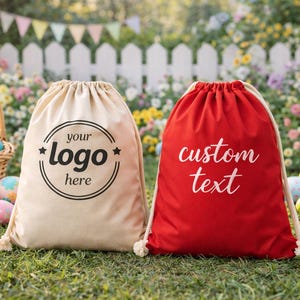 Two bags, one beige and one red, are placed on the grass in front of a white picket fence with Easter decorations.