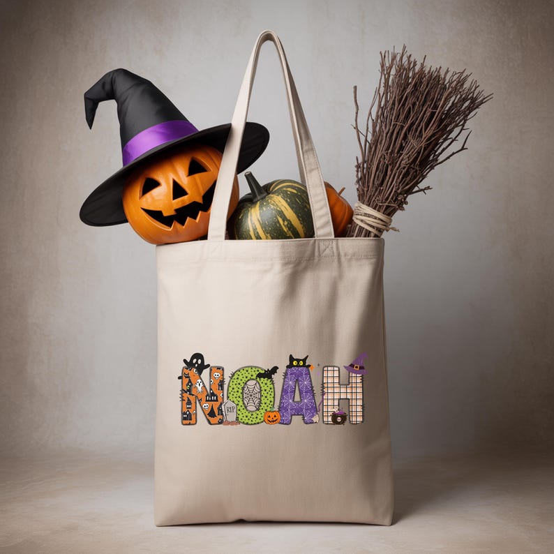 A Halloween-themed tote bag with the name "Noah" printed on it, along with a witch's hat, a jack-o-lantern, and a broom.