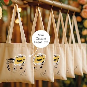 A row of beige tote bags with floral designs, each with a custom text label.