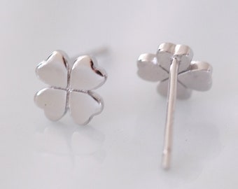 May include: A pair of silver four-leaf clover stud earrings. The earrings are small and delicate, and they would make a great gift for someone special.