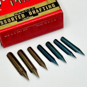 May include: A red box with the text "Made in U.S.A. Assorted Drafting 144 Pens" and "RFG U.S. PAT. OFF" and "MADE IN U.S.A."  The box is open and there are eight different types of drafting pen nibs on a white surface. The nibs are in two colors, silver and blue.