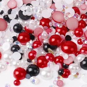May include: Assortment of red, white, and black round pearl-like beads and rhinestones.