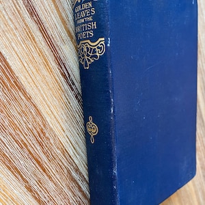 May include: A blue hardcover book with gold lettering on the spine that reads "Golden Leaves from the British Poets".