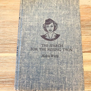 May include: The Search for the Missing Twin by Helen Wells, a vintage paperback book with a blue cover and a black and white illustration of a woman wearing a hat and uniform.