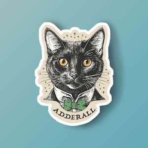 May include: A black cat with a green bow tie and the word "Adderall" printed below. The cat is drawn in a vintage style with a white background.