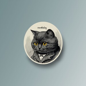 May include: A black cat with yellow eyes wearing a bow tie and a jacket. The cat is looking at the viewer with a serious expression. The text "Overthinking" is written above the cat.