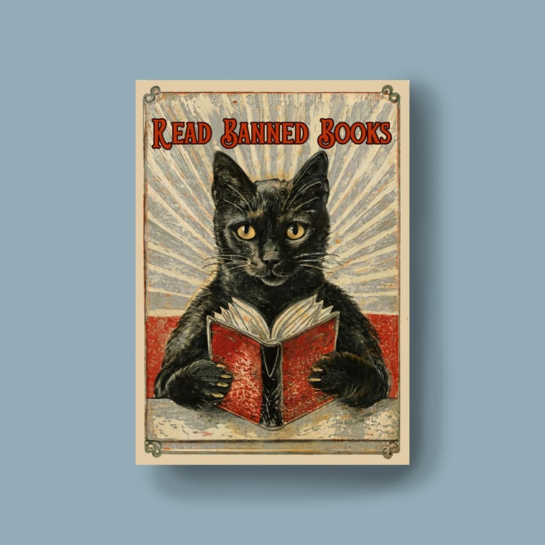 May include: A vintage-style poster with a black cat reading a red book. The poster has the text "Read Banned Books" in a red banner at the top.