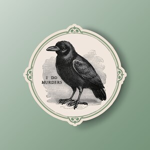 May include: A black crow illustration inside a decorative oval frame with the text "I DO MURDERS". The crow is depicted in a vintage style, with detailed feathers and a prominent beak. The frame has a light green border and is set against a light green background.