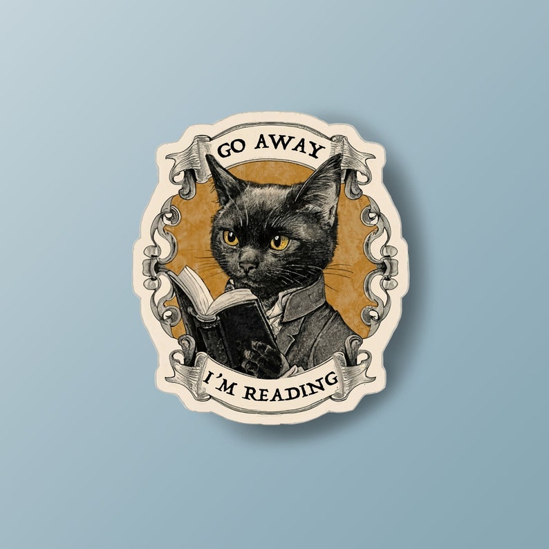 May include: A black cat wearing a waistcoat and holding a book, with the text "Go Away I'm Reading" in a decorative frame.