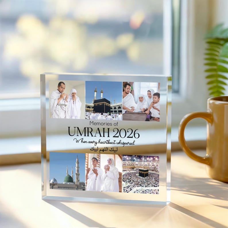 May include: A clear acrylic photo block featuring multiple images and the text "Memories of Umrah 2026." The block displays photographs of religious sites and people in white garments. The text includes English and Arabic phrases.